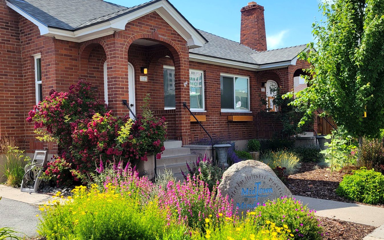 Midtown Mindfulness building entrance with garden in bloom